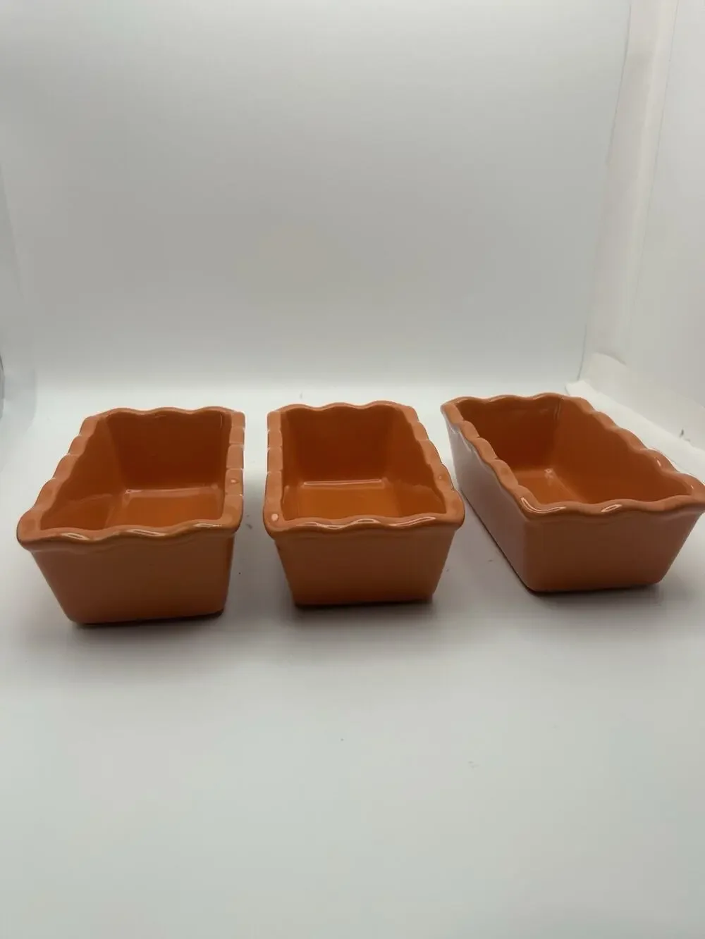 3 Stoneware Loaf Pans With Scalloped Edges.